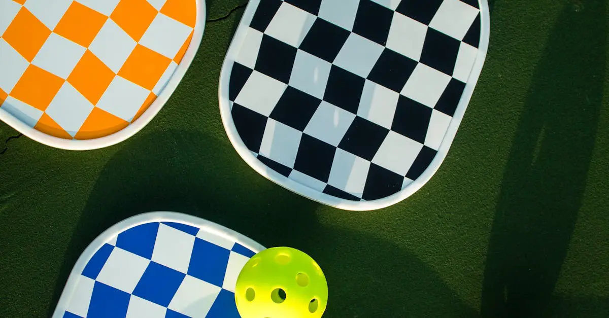 Three paddles with orange, black, and blue checkerboard patterns and a yellow perforated ball lie on a green surface.